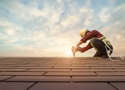 Image of a Roofer working on a Residential House.